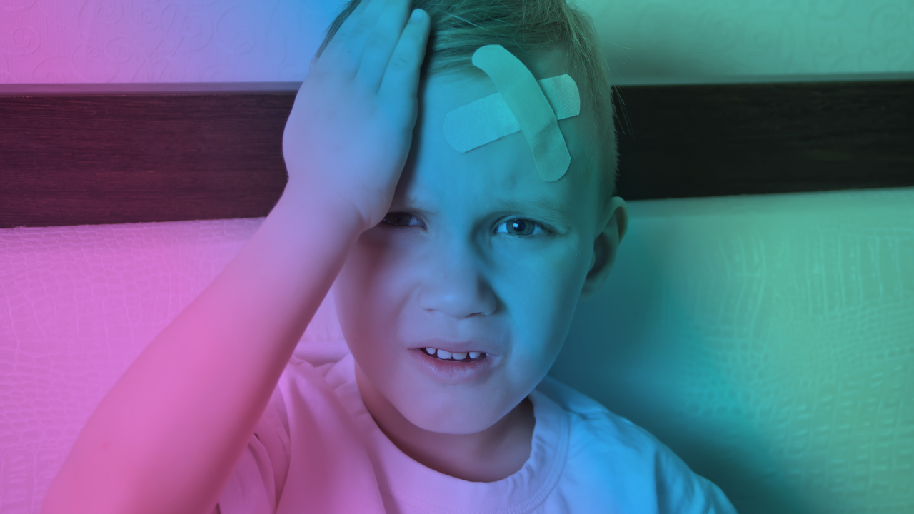 Child holding his head after sustaining a concussion